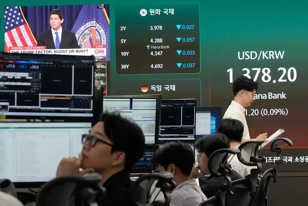 Börsgolvet i Seoul, med Fed-chefen Kevin Warsh i bakgrunden.