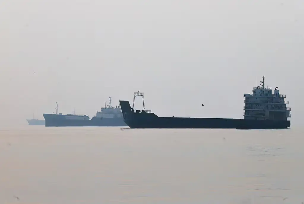 Commercial vessels appear anchored in the Strait of Hormuz off Bandar Abbas, Iran.